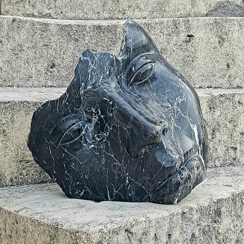 sculpture face in black marble work of art