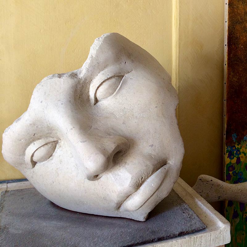 Hand carved natural stone face sculpture