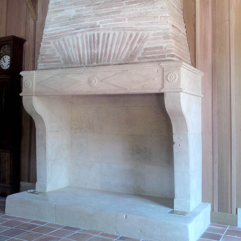 natural limestone fireplace with carved lintel and simple jambs