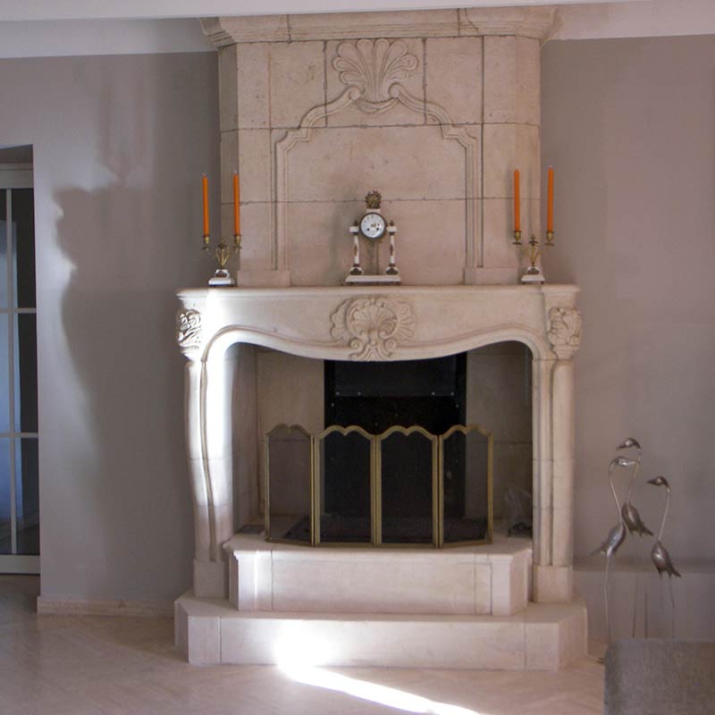 ashlar style fireplace with carved lintel and ornamented and moulded overmantel