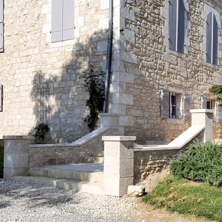 small ashlar pillars with low walls and external steps