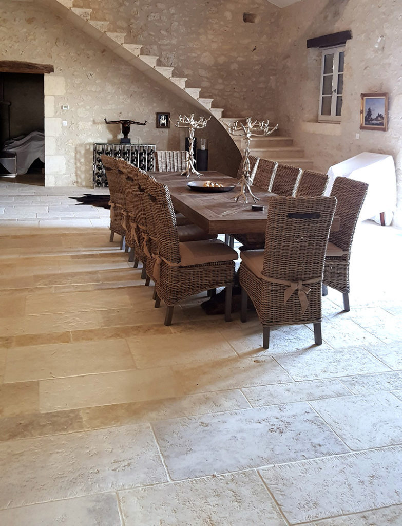 interior stone paving made to measure in natural limestone in the vast dining room of this very old Gers house renovated with respect for natural materials